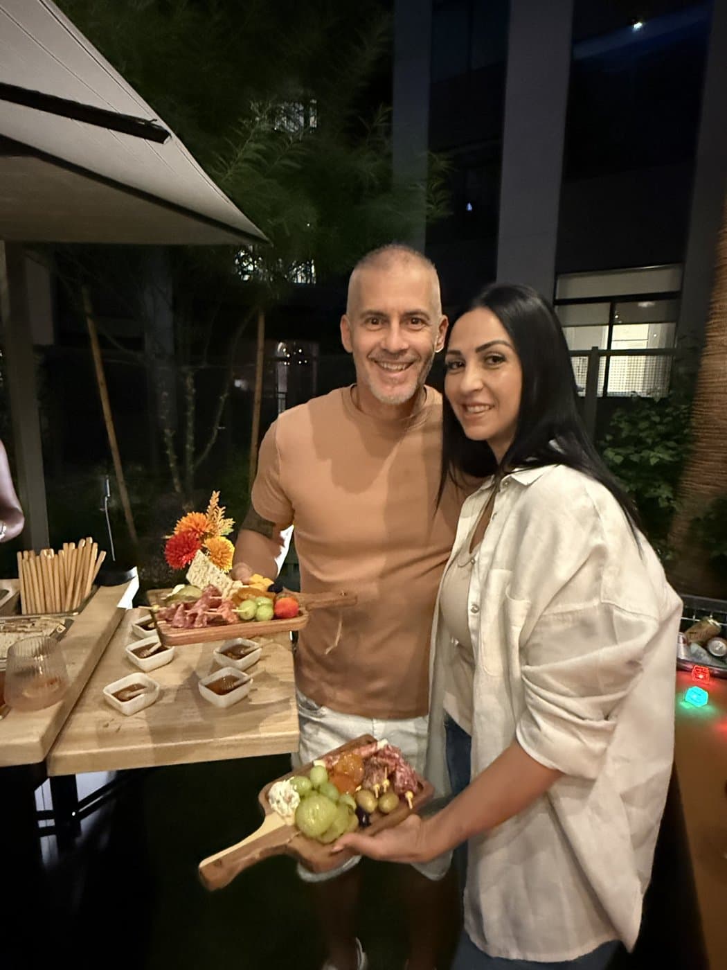 A smiling couple showing off the boards I made just for them
