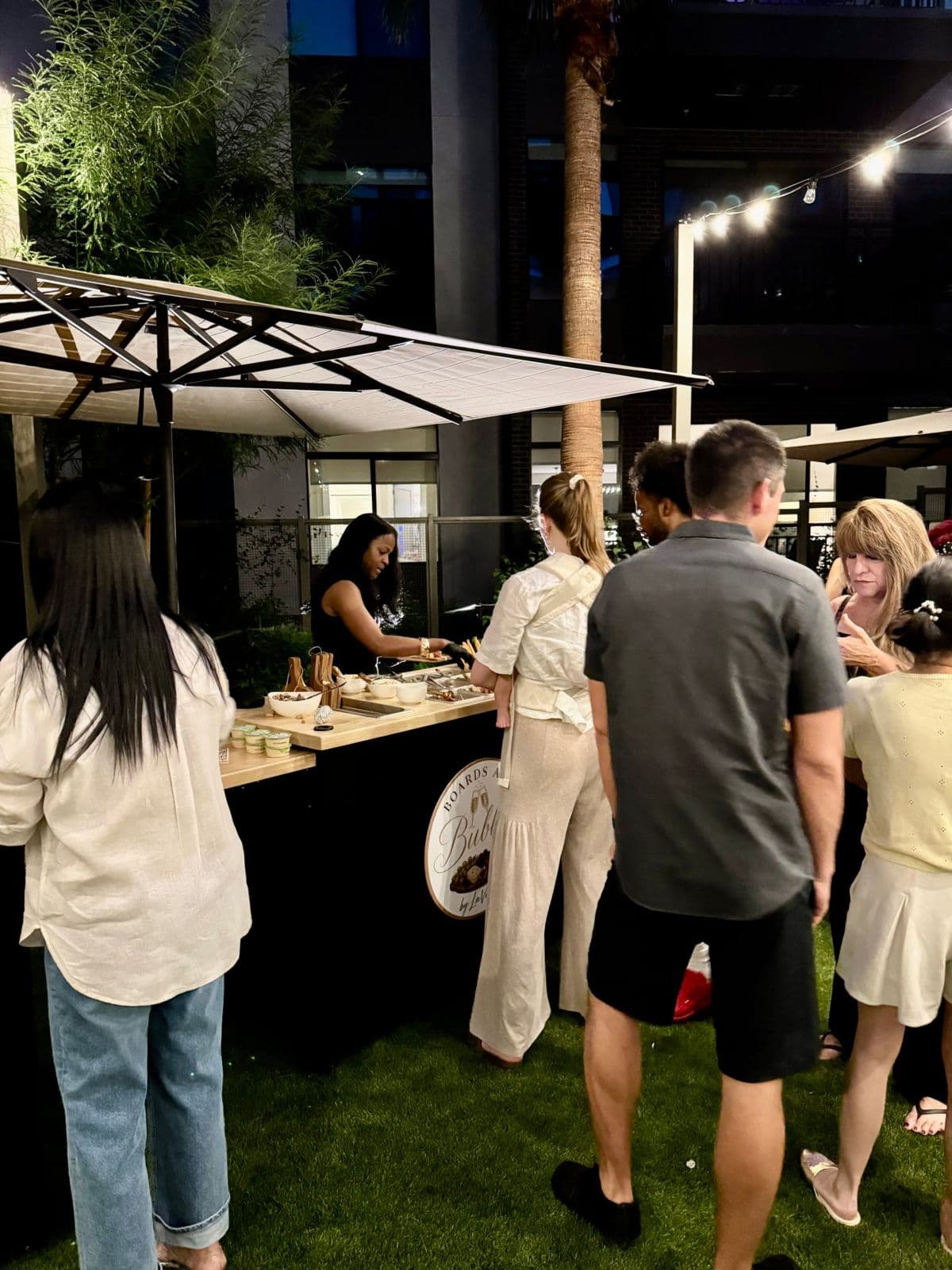 Guests gathered at the Boards and Bubbly cart